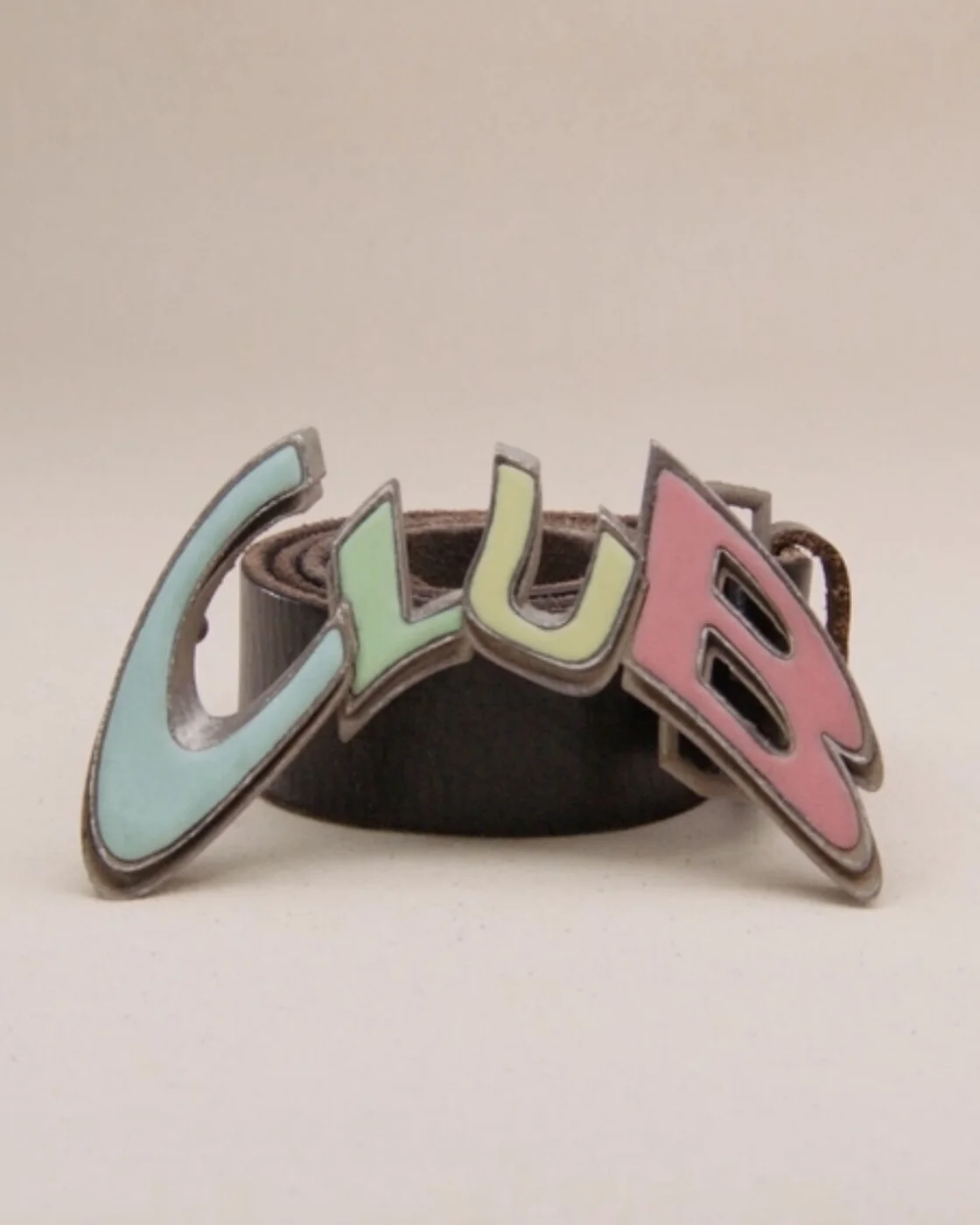 The club buckle on its belt, CLUB spelled in enamelled letters